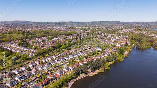 Photography A high-angle aerial drone photo capturing the lush residential suburbs of Cardiff, situated west of Roath Park Lake
