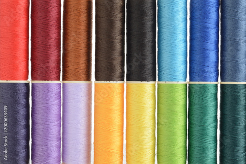 two rows of colorful sewing thread