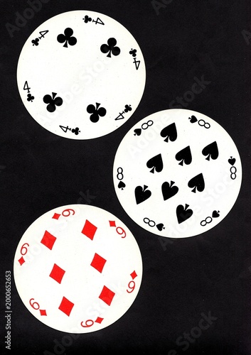 A hand of three vintage round playing cards isolated on a black background.