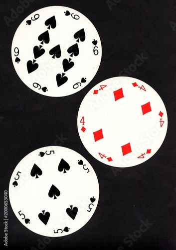 A hand of three vintage round playing cards isolated on a black background.