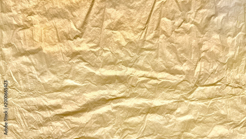 crinkled golden foil texture gleaming with subtle sheen abstract luxury background evoking opulence and vintage elegance