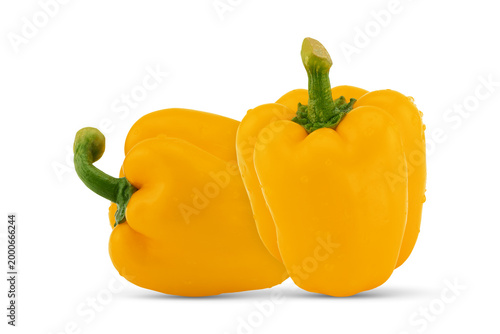 Two fresh yellow bell peppers on white background with clipping path