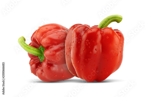 Two fresh red bell peppers on white background with clipping path