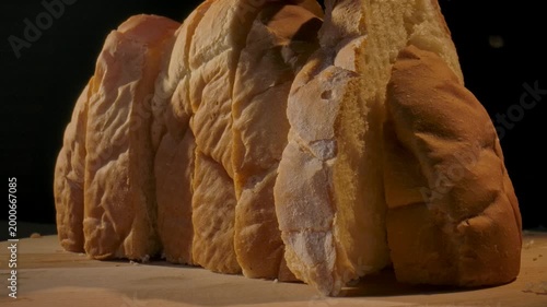 Close up of freshly sliced bread lined up on a wooden surface. Concept of homemade food, bakery products, content for bakeries and bread factories, store, supermarket, gastronomy and culinary art