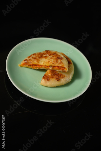 The delicious Orleans chicken pancake on the plate on the table