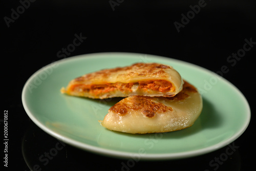 The delicious Orleans chicken pancake on the plate on the table