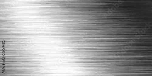Polished stainless steel plate with a brushed metal texture featuring a shiny silver metallic pattern on a gray industrial aluminum surface