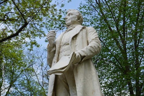 Side profile close up portrait of the landmark marble statue of the German composer Albert Lortzing at the Lortzing memorial in Tiergarten Park, Berlin, Germany