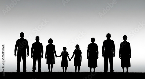 Silhouette of a large family standing together against a bright sky.