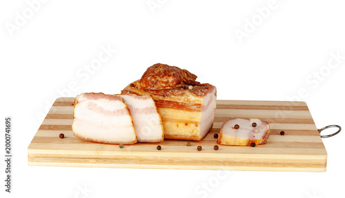 Pork bacon on a wooden board.