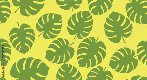 Seamless pattern of green monstera deliciosa leaves on a bright yellow background creating a tropical summer atmosphere.