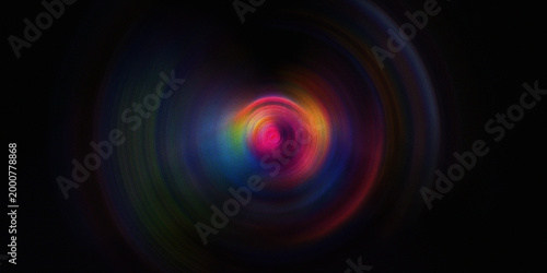 Colorful radial spiral motion blur on black background with vibrant glowing neon light effects and grainy textured circular.