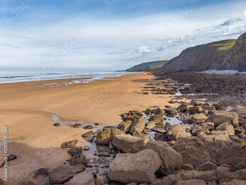 Early morning low tide on a sand and rocky Cornwall beach