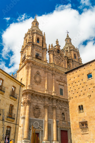 Historic La Clerecia church towers and the famous Casa de las Conchas with shell-shaped stone carvings in Salamanca, Spain. A stunning example of Spanish Baroque and Gothic architecture