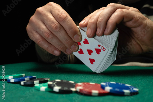 Canvas Print A person holds a deck of playing cards and prepares to deal in a poker game