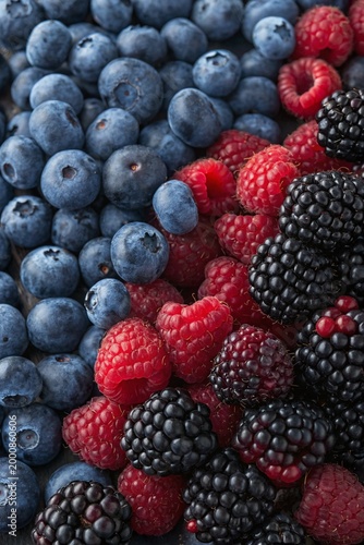 Full frame texture of mixed forest berries with blueberries, blackberries, and raspberries