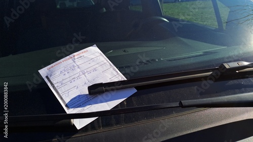 Canvas Print Close-up of a traffic ticket written on the windshield, written in Italian
