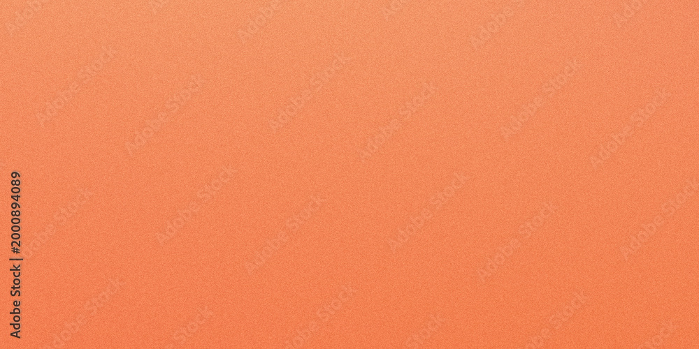 Fototapeta premium A close up view of a vibrant peach-orange paper surface, showcasing its subtle grainy texture and uniform color.