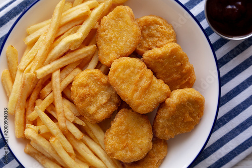 Chicken Nuggets with Fries on a Plate, top view. Close-up.