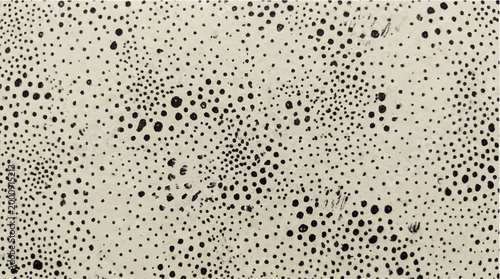 Abstract pattern of scattered dark dots of varying sizes on a light speckled background