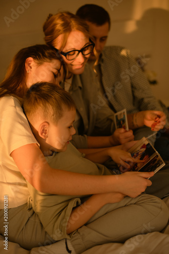 family tradition: looking at family photos and immerse together in memories