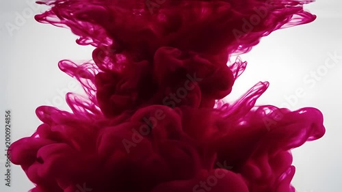 Crimson Ink Cloud Dissolving in Clear Water Abstract Motion.