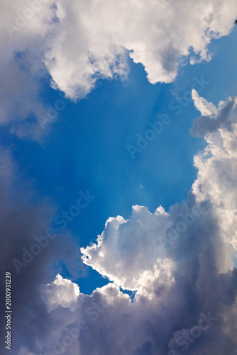 Gray rain clouds and blue sky in summer day.
