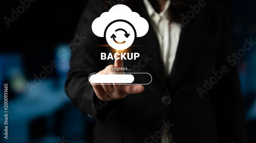 Fotografi A business professional uses a touchscreen to initiate a cloud backup process, showcasing modern technology and data security in a contemporary office setting