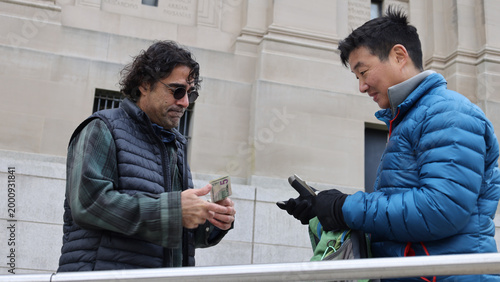 Fényképezés two men meet to buy sell a backpack for cash (transaction barter deal commerce s