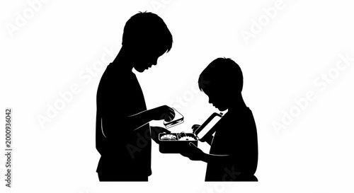 Silhouette of two young boys sharing food from a lunchbox together.