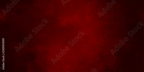 A dark red abstract grunge background features a textured vintage paper pattern with an aged paint surface and grungy material design perfect for a Christmas card wallpaper or old wall backdrop