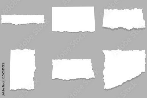 Torn paper edges set with ripped white paper pieces on gray background for creative design