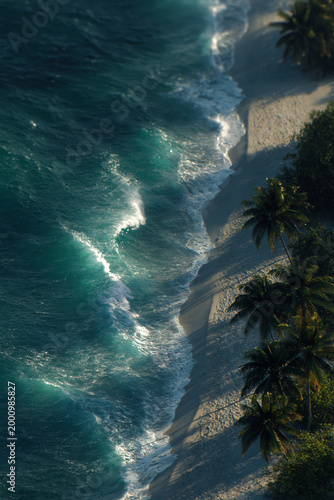 Ocean waves crashing along tropical sandy beach