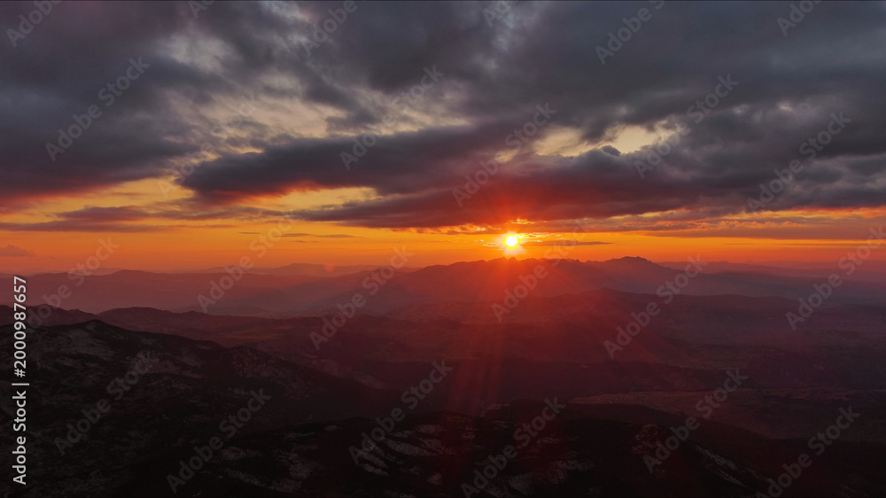 Fototapeta premium Sunset over mountain with dramatic clouds