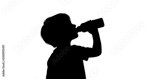 Silhouette of a young child drinking water from a bottle.