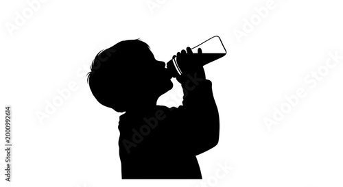 Silhouette of a young child drinking from a glass bottle.