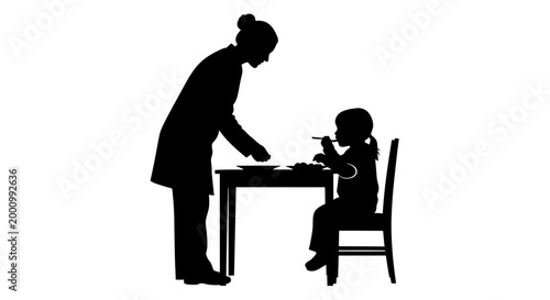 Silhouette of a mother serving food to her child at a dining table.