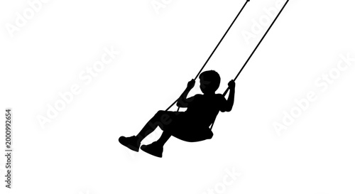 Silhouette of a happy young child swinging on a playground swing.