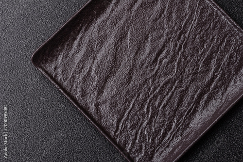 A blank slate board on a dark background for Asian food. A blank slate board