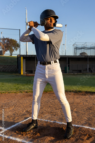 Konstfotografi African American male standing in batter's box on baseball field wearing helmet