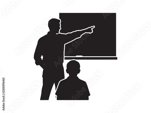 Man and boy looking at blackboard in classroom.