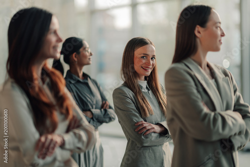 Businesswomen team standing with crossed arms in modern office, showing female leadership, confidence, and career success