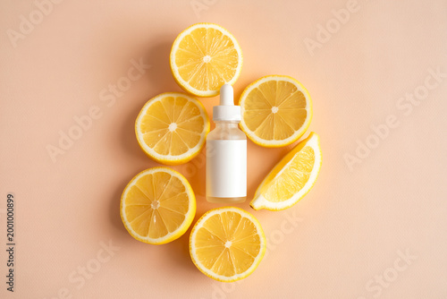 Dropper bottle with citrus serum surrounded by fresh lemon slices for natural