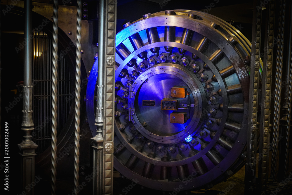 Fototapeta premium photo of a large bank vault in blue lighting 