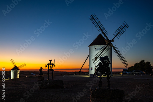 Εκτύπωση καμβά Windmills of Mota del Cuervo at sunset with Don Quixote