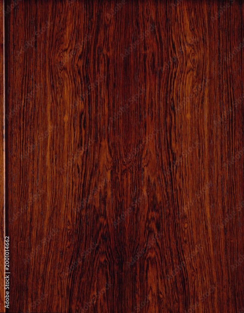 Fototapeta premium Jacaranda rosewood veneer with dramatic dark red and black grain streaks, exotic figured hardwood surface for luxury interiors.