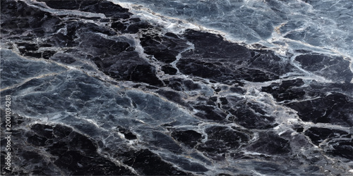 Abstract, textured, monochromatic surface, showcasing the intricate detail of rough, weathered, and eroded stone and the subtle shades of light and shadow, evoking a sense of ancient history.