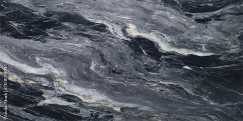 A close-up view unveils the intricate textures of a dark marble surface, with mesmerizing swirling patterns in shades of grey and hints of white, creating a captivating display of natural beauty.
