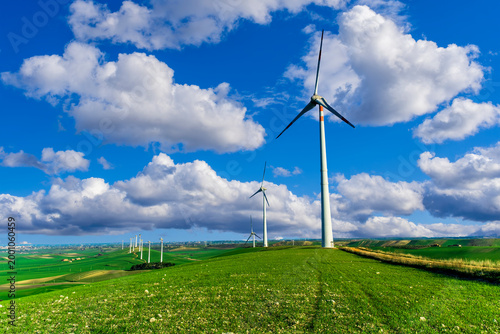 Принти на полотні wind power plant concept of wind turbine close up and blue sky on background