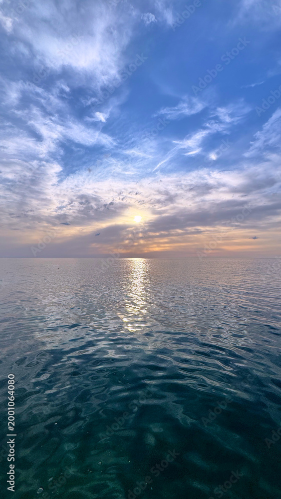 Obraz premium Adriatic Sea reflecting golden sunset over calm waters along Montenegro coast